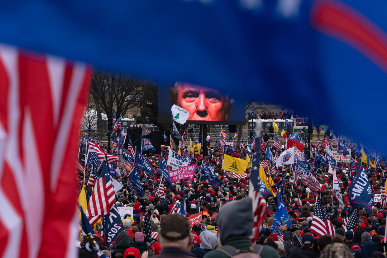President Trump appears on a large screen at the "Save America Rally" on Jan. 6, the day that Congress was slated to certify the electoral victory for his opponent. Following his inflammatory speech, rioters stormed the Capitol.