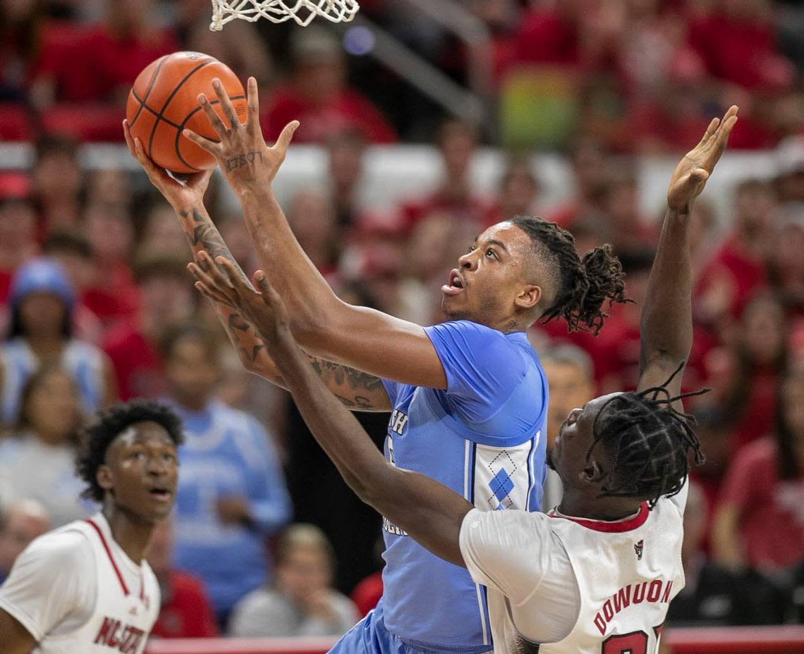 North Carolina’s Armando Bacot (5) drives to the basket against N.C. State’s Ebenezer Dowuona (21) in the second half on Sunday, February 19, 2023 at PNC Arena in Raleigh, N.C.