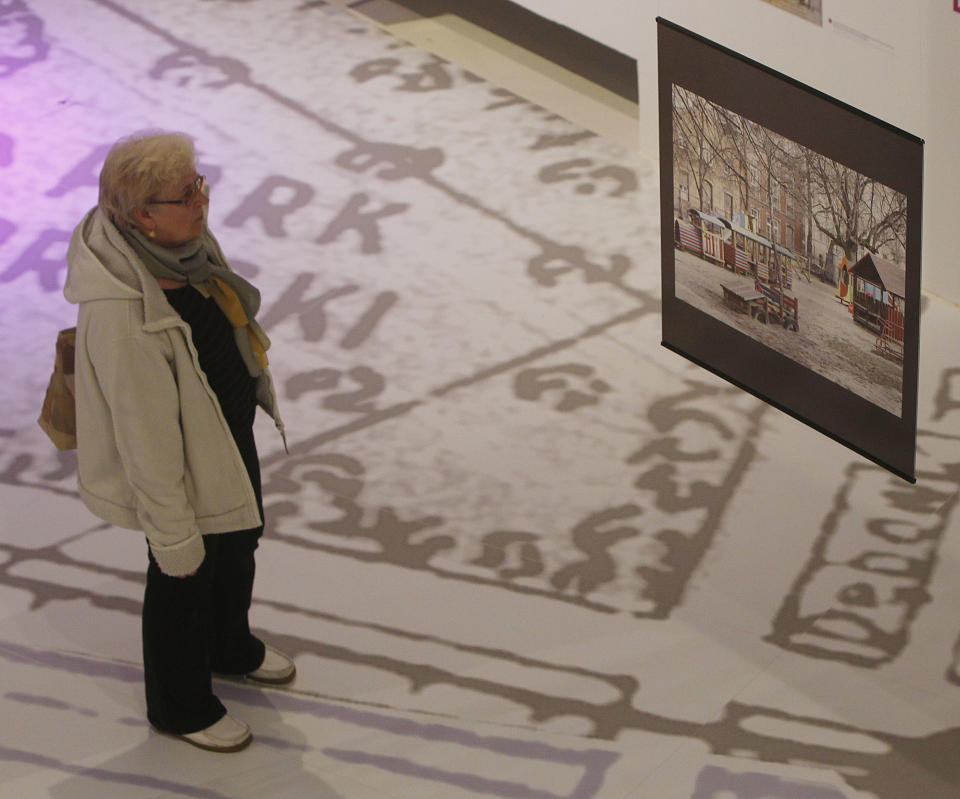 A visitor looks at an contemporary image of a site that used to be part of the Jewish district in pre-World War II Warsaw, at a new exhibition by the Museum of the History of Polish Jews, in Warsaw, Poland, on Thursday, March 27, 2014. The exhibition that will run through June 30 documents Jewish life in Warsaw before the Holocaust.(AP Photo/Czarek Sokolowski)