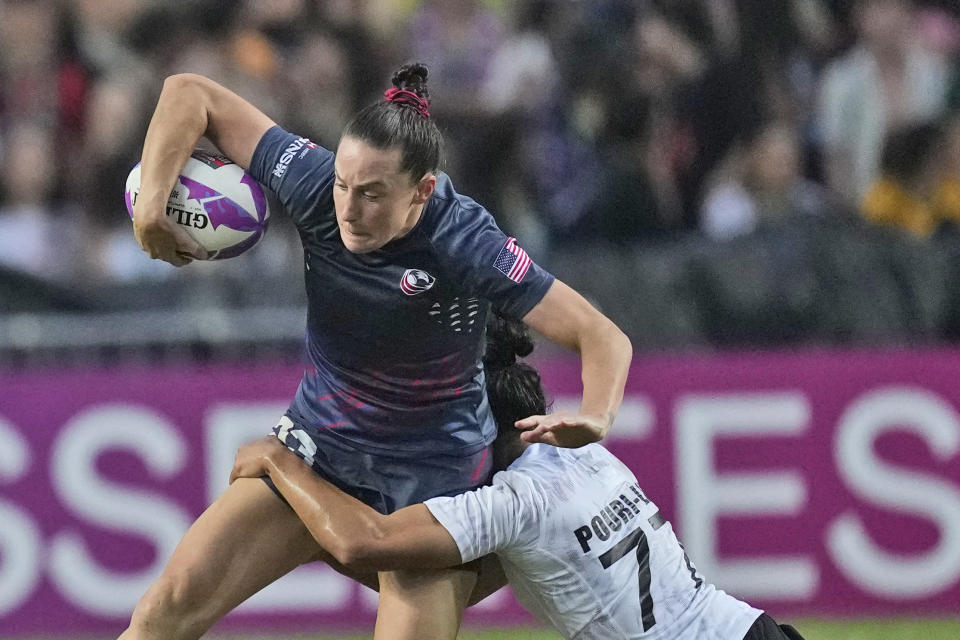 FILE - New Zealand's captain Risi Pouri-Lane tackles Lauren Doyle, captain of team United States, during the women's final match in the Hong Kong Sevens rugby tournament in Hong Kong, Sunday, April 7, 2024. Lauren Doyle and Alev Kelter will appear at their third Olympics with a shot at helping the United States win its first rugby sevens medal in Paris. (AP Photo/Louise Delmotte, FIle)