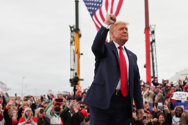 U.S. President Donald Trump gestures as he arrives to a campaign event at MBS International Airport, in Freeland