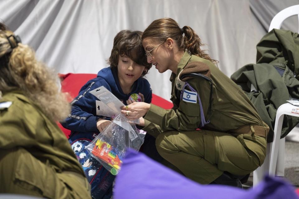 This handout photo provided by the Israel Prime Minister Office shows Naveh Shoham, 8 years old, upon his arrival in Israel after being freed. Naveh was one of the 13 Israeli hostages that Hamas released late Saturday, Nov. 25, 2023, in the second round of swaps under a cease-fire deal. (Israel Prime Minister Office/Handout via AP)