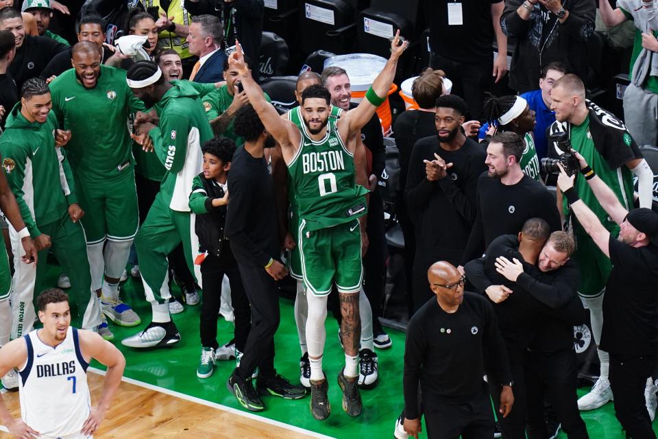 Jayson Tatum celebrates with the Celtics bench.