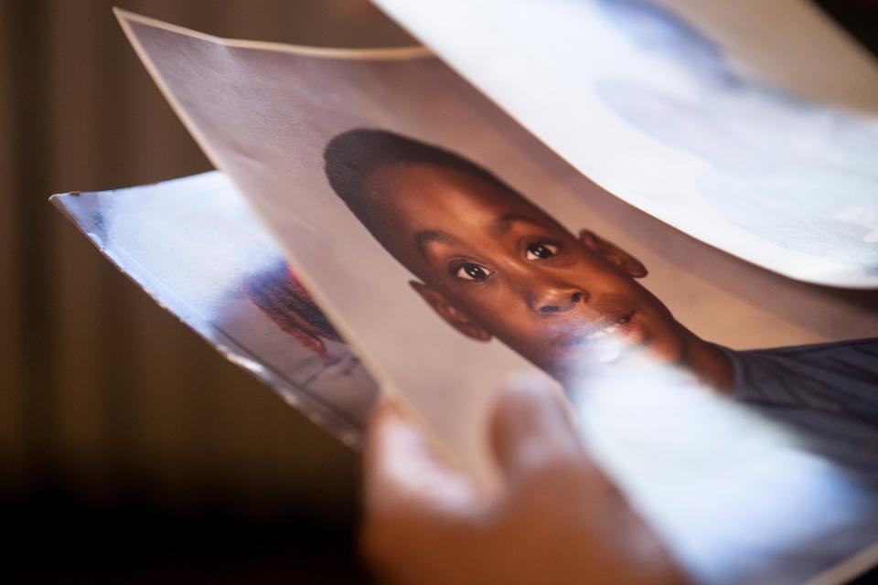 Marilyn Donald, the mother of Marcus Donald, looks at family photos of Marcus as a child and teenager in her mother’s home in Memphis, Tenn., on March 20, 2023. Donald died while in custody at Shelby County Jail and another inmate has been charged with his murder. 