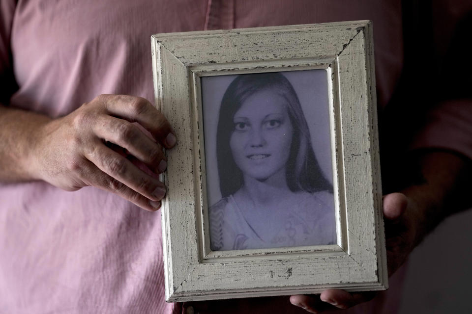 Pedro Sandoval, who was stolen as a baby during Argentina's bloody dictatorship (1976-1983) and grew up with a different identity, shows a photograph of his biological mother Liliana Fontana in Buenos Aires, Argentina, Monday, Aug. 7, 2023. Sandoval's parents are among the 30,000 missing persons counted by humanitarian organizations, and he was identified as a grandson in 2006. (AP Photo/Natacha Pisarenko)