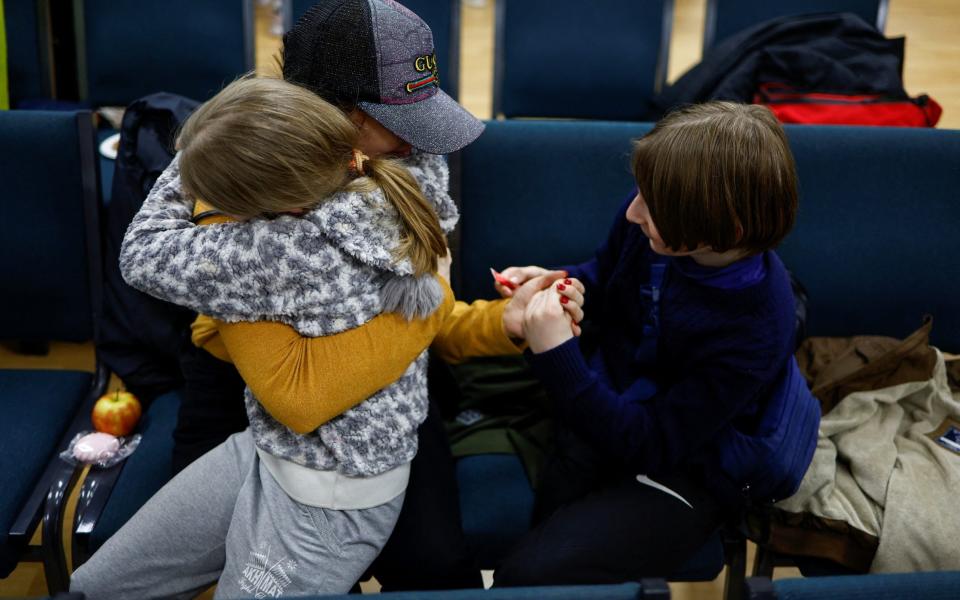Anastasiia holds her daughter Valeriia and son Maksym, who went to a Russian-organised summer camp from non-government controlled territories and were then taken to Russia, after they returned via the Ukraine-Belarus border, in Kyiv, Ukraine April 8, 2023. - REUTERS/Valentyn Ogirenko