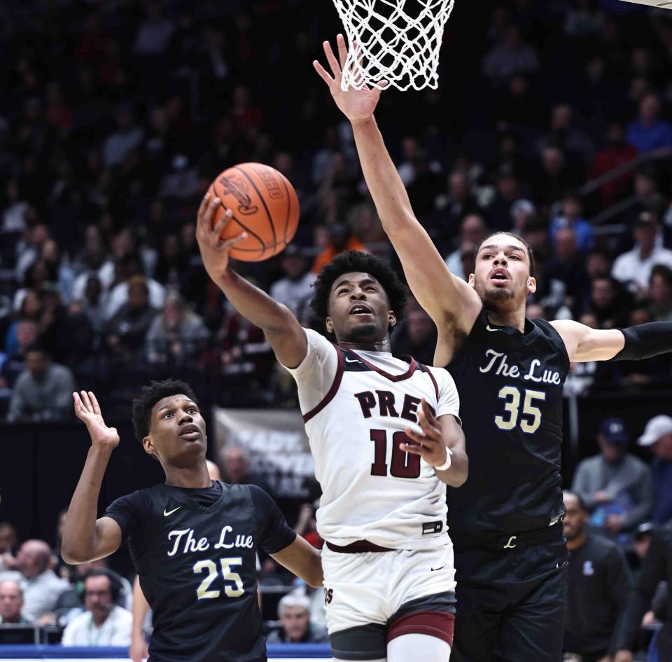 Harvest Prep's Brandon Roddy drives to the basket against Cleveland Heights Lutheran East's Jesse McCulloch (35) and Ronald Taylor during the Division III state championship game Sunday at University of Dayton Arena.