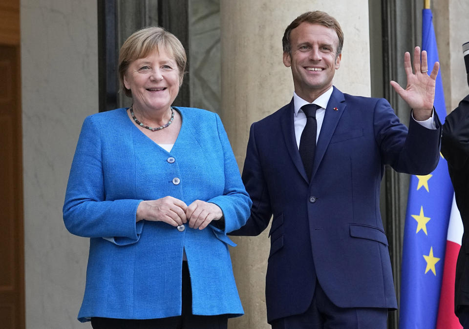 France's President Emmanuel Macron, right, welcomes German Chancellor Angela Merkel prior to a meeting at the Elysee Palace, in Paris, Thursday, Sept. 16, 2021. (AP Photo/Michel Euler)