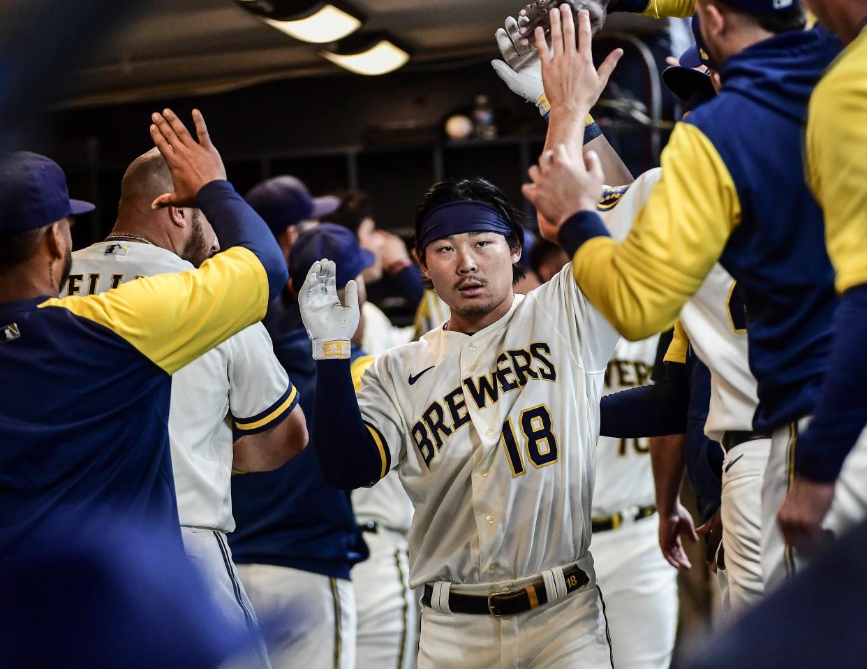 Milwaukee Brewers designated hitter Keston Hiura is greeted in the dugout after hitting a three-run home run in the seventh inning Wedneday afternoon.