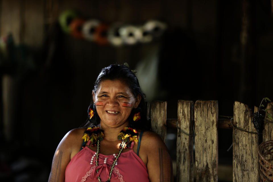 Tenetehara Indigenous Sandra Muxi Tembe smiles as she talks about the importance of the indigenous women's council formed to guide families on the new coronavirus pandemic, in the Alto Rio Guama Indigenous Territory, where they have enforced six months of isolation during the COVID-19 pandemic, near the city of Paragominas, state of Para, northern region of Brazil, Monday, Sept. 7, 2020. The Indigenous group, also known as Tembe, held a festival this week to celebrate and give thanks that none of their members have fallen ill with COVID-19, after closing their area off in March. (AP Photo/Eraldo Peres)