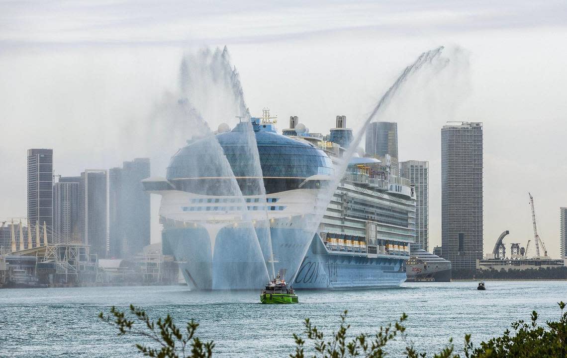 A Miami Dade Fire Boat salutes the Royal Caribbean’s Icon of the Seas, the world’s largest cruise ship, as it heads to PortMiami.