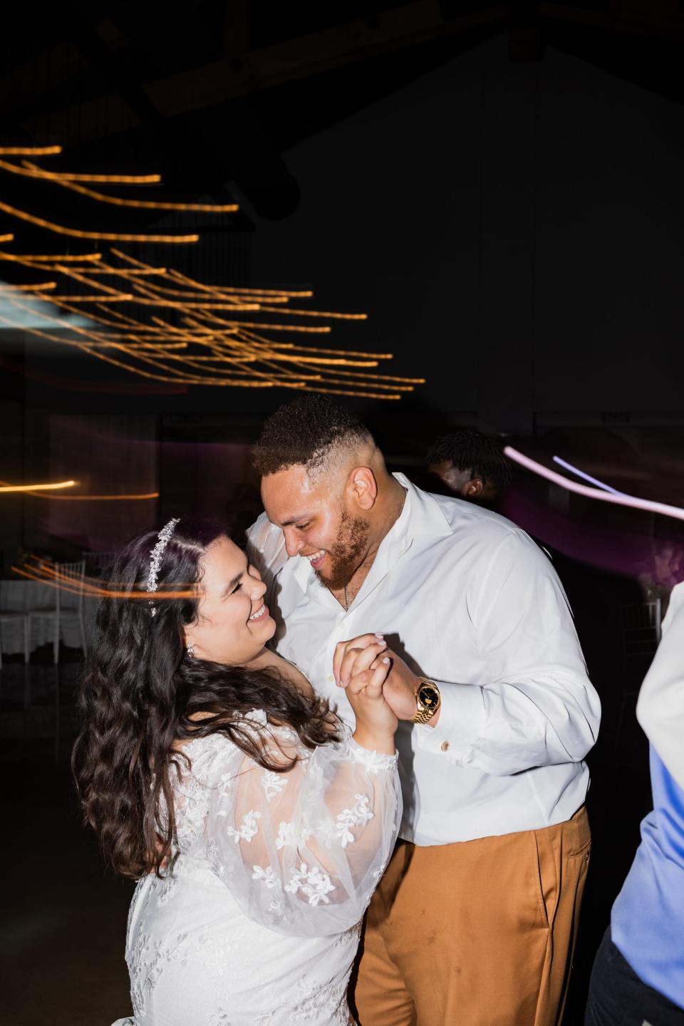 A bride and groom dance together during their wedding reception.