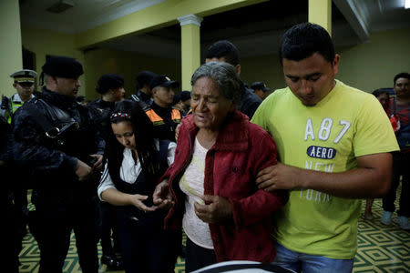 Relatives of a slain policeman react during a homage for their loved one and two colleagues, who were killed during an attack, at the headquarters of the Civil National Police (PNC) in Guatemala City, Guatemala, March 21, 2017. REUTERS/Luis Echeverria