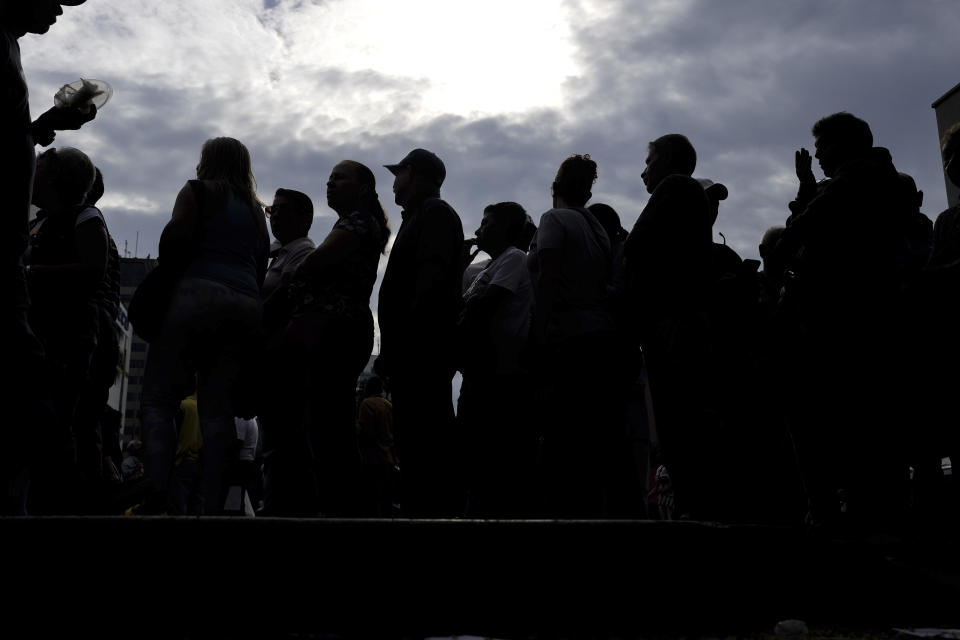 People wait to open a polling station during primary election at the Luis Brion square in Caracas, Venezuela, Sunday, Oct. 22, 2023. (AP Photo/Matias Delacroix)
