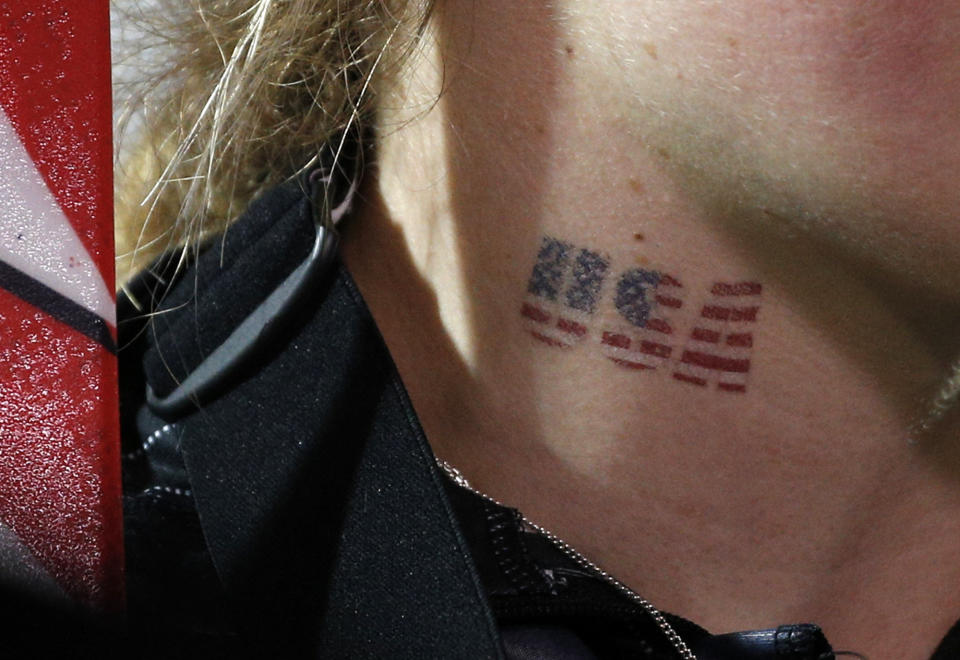 United States' Mikaela Shiffrin wears a temporary tattoo as she celebrates her gold medial win in the women's slalom at the Sochi 2014 Winter Olympics, Friday, Feb. 21, 2014, in Krasnaya Polyana, Russia. (AP Photo/Christophe Ena)