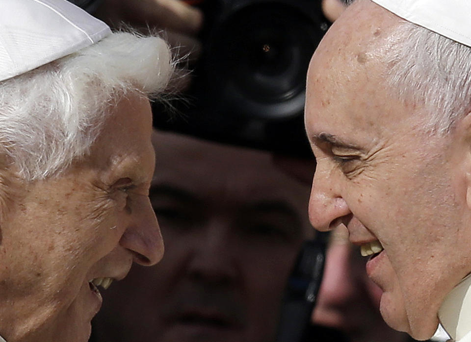 FILE - Pope Francis, right, greets Pope Emeritus Benedict XVI prior to the start of a meeting with elderly faithful in St. Peter's Square at the Vatican on Sept. 28, 2014. Pope Emeritus Benedict XVI, the German theologian who will be remembered as the first pope in 600 years to resign, has died, the Vatican announced Saturday. He was 95. (AP Photo/Gregorio Borgia, File)