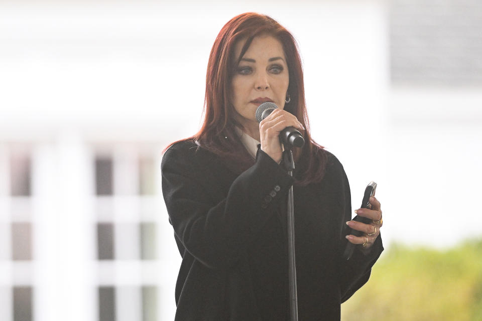 Priscilla Presley reads a poem written by granddaughter Harper Lockwood during a memorial service for her daughter Lisa Marie Presley at Graceland Sunday, Jan. 22, 2023, in Memphis, Tenn. Lisa Marie died Jan. 12 after being hospitalized for a medical emergency and was buried on the property next to her son Benjamin Keough, and near her father Elvis Presley and his two parents. (AP Photo/John Amis)