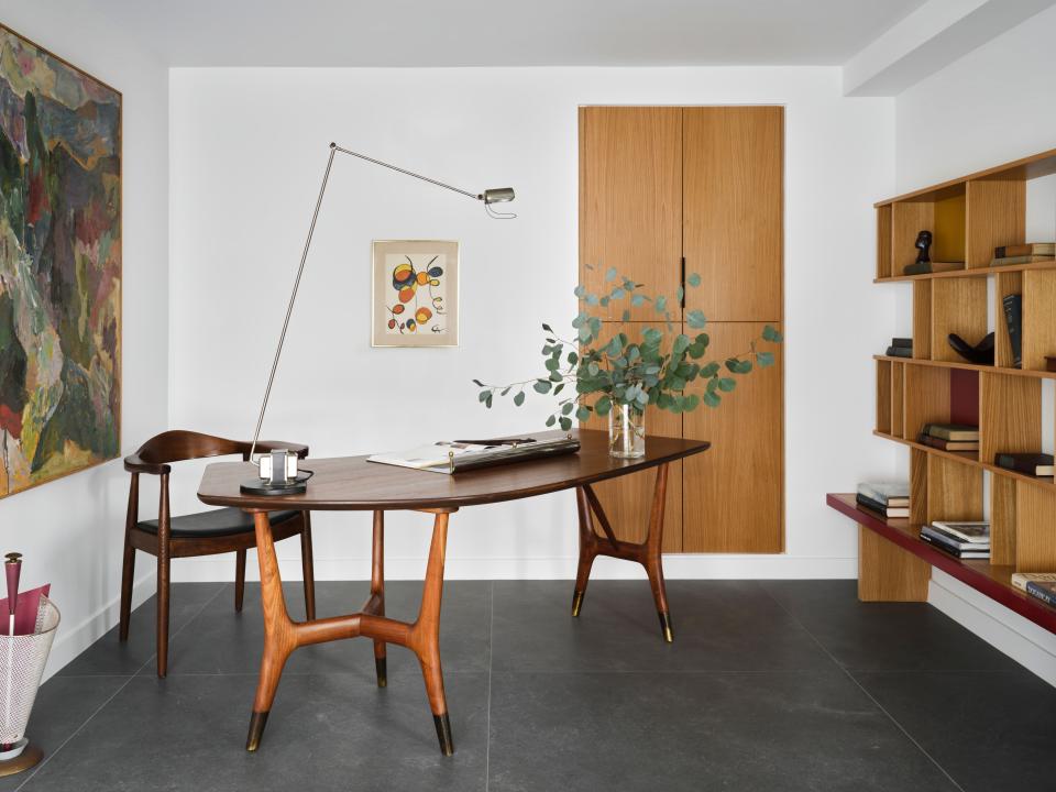 The centerpiece of the office is a desk by Italian designer Louis Paolozzi, from the 1960s. A large painting by Alexander Calder and a smaller one by Robert Chuey grace the walls.