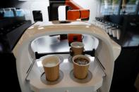 A robot that takes orders, makes coffee and brings the drinks straight to customers is seen in Daejeon