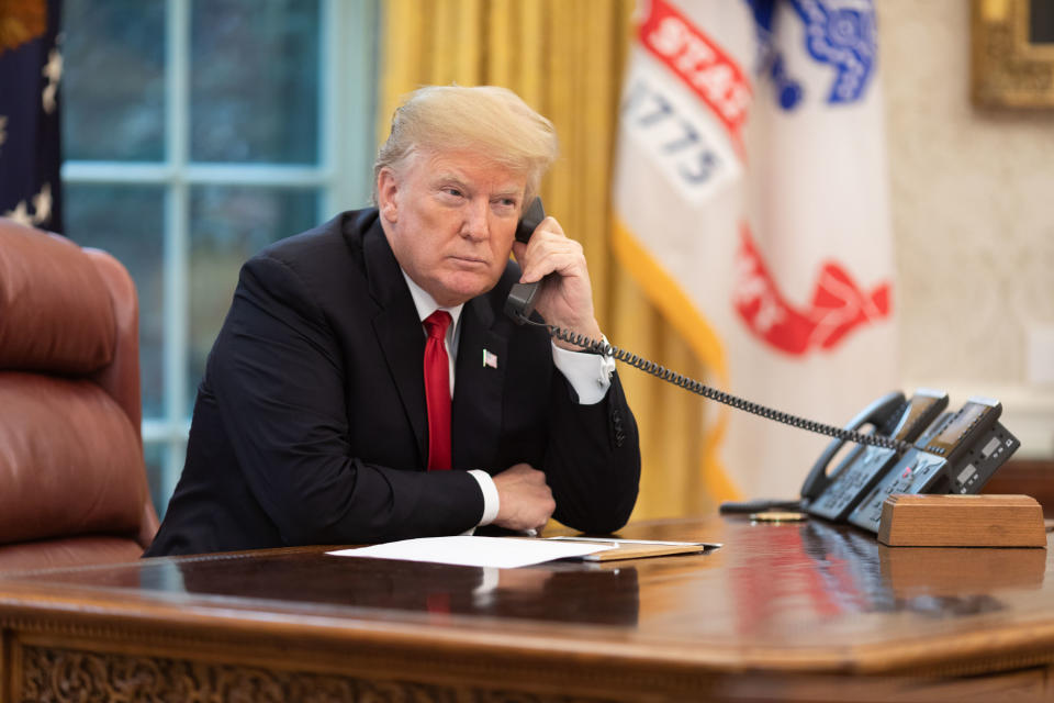 President Trump on the phone in the Oval Office.