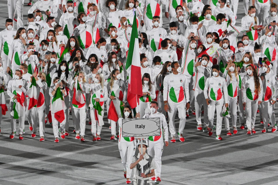 <p>Italy wore white ensembles — complete with an Italian flag on the belly — and red sneakers. Some athletes wore green, red and white scarves in their hair, too.</p>