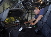 Avionics mechanic Mike Luong inspects the control panel of Sikorsky Firehawk helicopter at the California Department of Forestry and Fire Protection's Sacramento Aviation Management Unit based at McClellan Airpark in Sacramento, Calif., Friday, July 23, 2021. Firefighters are trying to become smarter in how they prepare for the drought- and wind-driven wildfires that have become more dangerous across the American West in recent years, including by adding aircraft like the Sikorsky Firehawk helicopters or military surplus C-130 transport aircraft retrofitted to drop fire retardant. (AP Photo/Rich Pedroncelli)