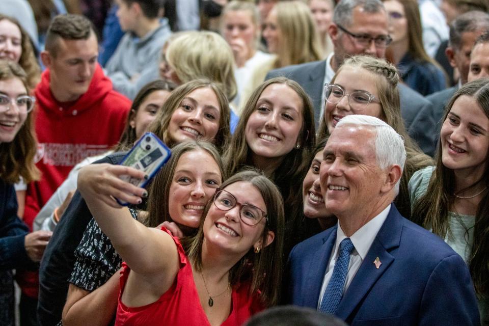 Former Vice President of the United States Mike Pence takes a photo with students after a roundtable discussing a proposal to provide educational scholarships to Michigan students at Lutheran North High School in Rochester Hills on Tuesday, May 17, 2022.