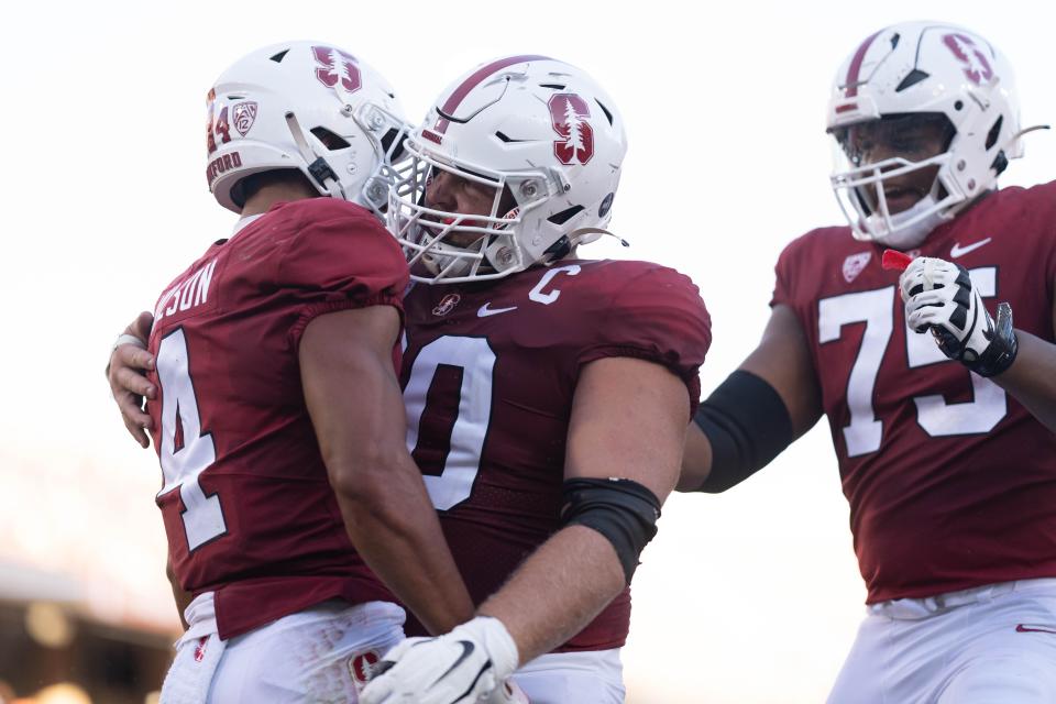 Stanford center Drake Nugent, center, celebrates with wide receiver Michael Wilson after scoring a touchdown against Colgate during the second quarter at Stanford Stadium on Sept. 3, 2022.