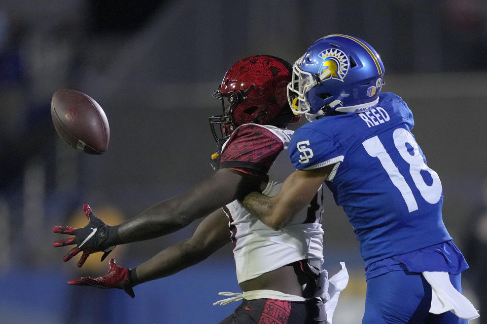 San Diego State wide receiver Isaiah Richardson, left, catches a pass against San Jose State cornerback Kenyon Reed (18) during the first half of an NCAA college football game Friday, Oct. 15, 2021, in San Jose, Calif. (AP Photo/Tony Avelar)