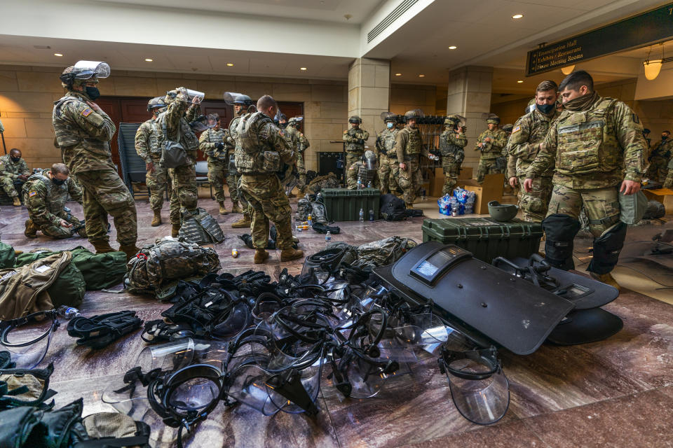 Members of the National Guard gather inside the Capitol Visitor Center, Wednesday, Jan. 13, 2021, in Washington as the House of Representatives continues with its fast-moving House vote to impeach President Donald Trump, a week after a mob of Trump supporters stormed the U.S. Capitol. (AP Photo/Manuel Balce Ceneta)