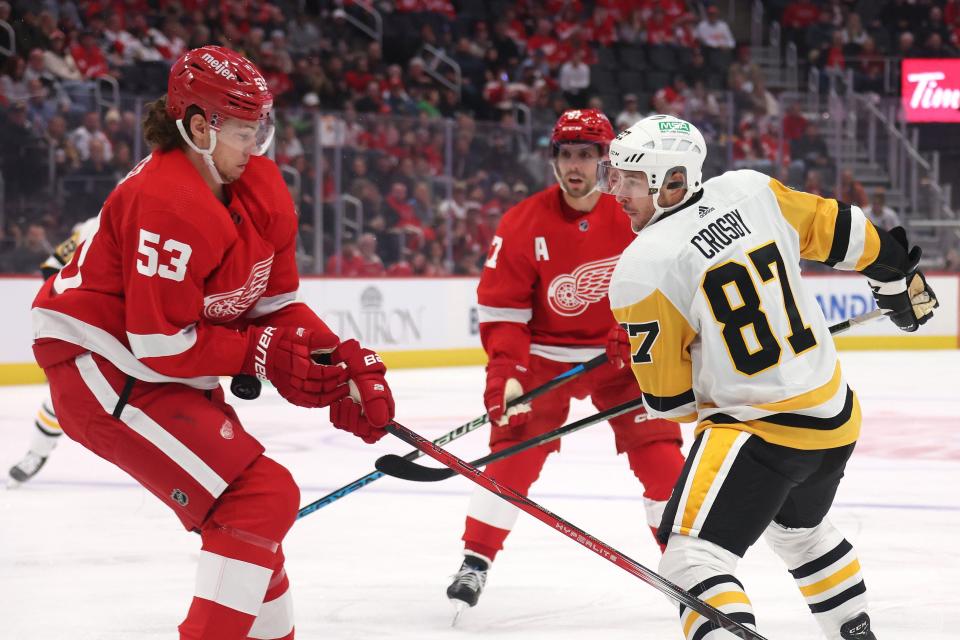Penguins forward Sidney Crosby battles for the puck with Red Wings defenseman Moritz Seider during the first period on Wednesday, Oct. 18, 2023, at Little Caesars Arena.