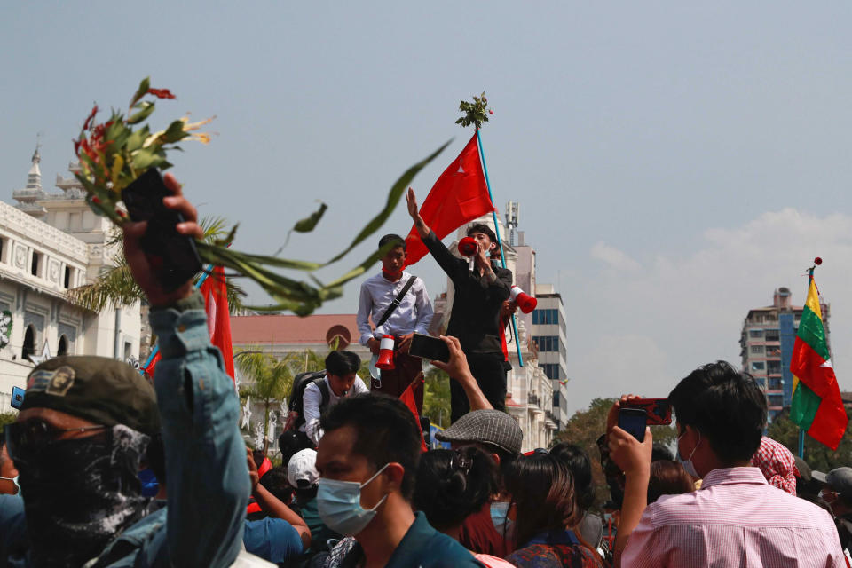 A man uses a loudspeaker as he addresses protesters who have gathered near Yangon City Hall in Yangon, Myanmar on Sunday, Feb. 7, 2021. Thousands of people rallied against the military takeover in Myanmar's biggest city on Sunday and demanded the release of Aung San Suu Kyi, whose elected government was toppled by the army that also imposed an internet blackout. (AP Photo)