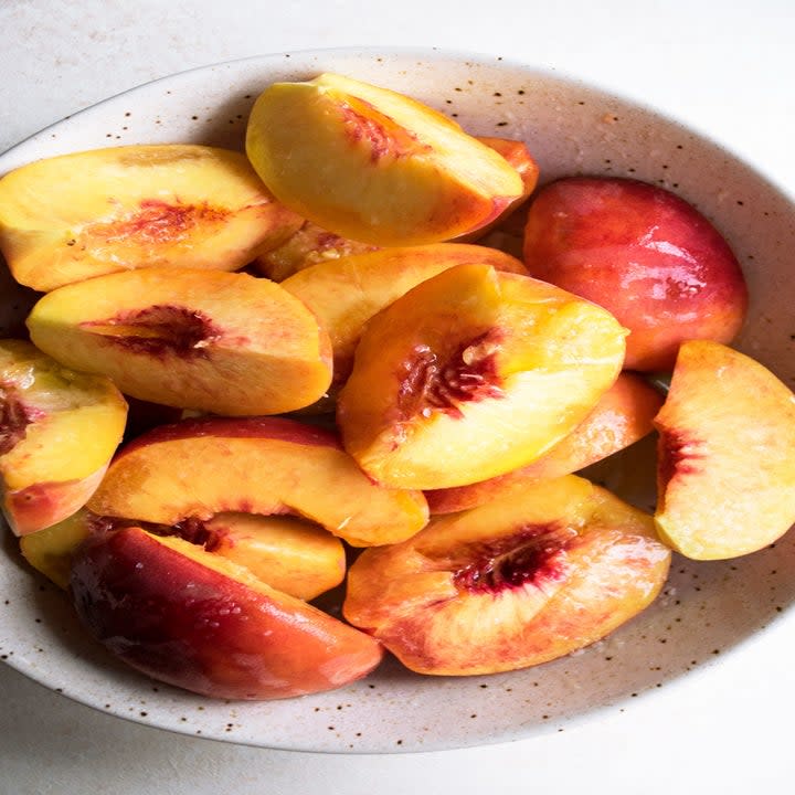 Sliced peaches in a bowl.