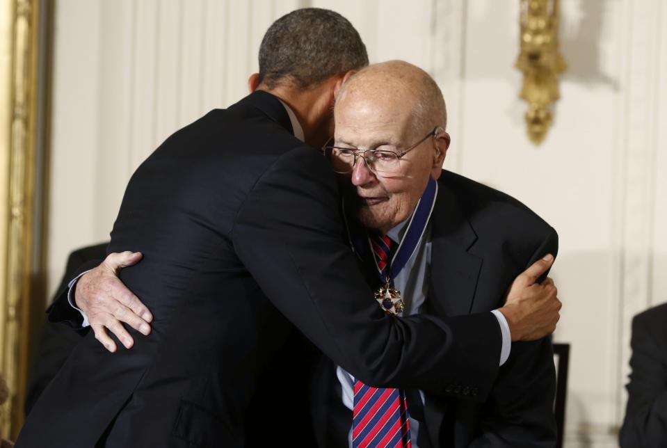 U.S. President Barack Obama (R) embraces U.S. Rep. John Dingell, the longest serving Member of Congress in American history, after presenting him with the the Presidential Medal of Freedom during a White House ceremony in Washington, November 24, 2014. (REUTERS/Larry Downing)