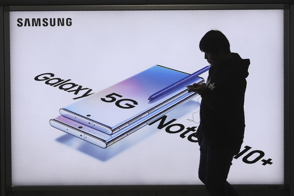 A man passes by an advertisement of Samsung Electronics' Galaxy 5G Note10+ smartphone at a subway station in Seoul, South Korea, Thursday, Oct. 31, 2019. Samsung Electronics said it operating profit for the last quarter fell by nearly 56%, with its robust sales of smartphone, displays and TVs offset by a continuously weak market for computer chips. (AP Photo/Ahn Young-joon)