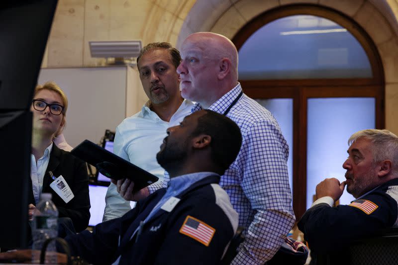 Traders work on the floor of the NYSE in New York