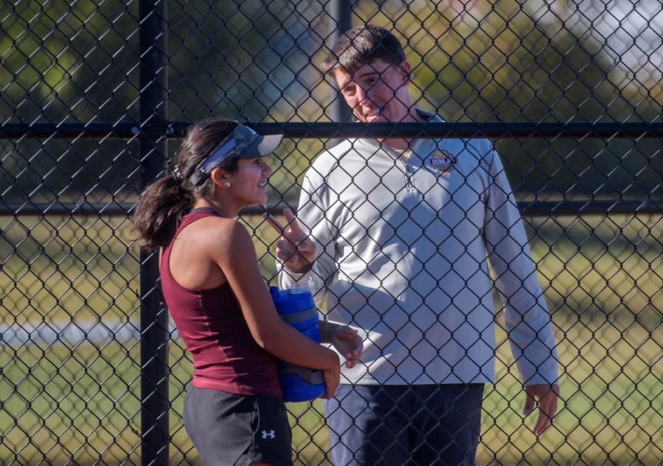 Dunlap head tennis coach Pat Gornik talks with freshman Maya Baman during her match against Metamora senior Carly Edwards on Sept. 27, 2022 at Dunlap High School.