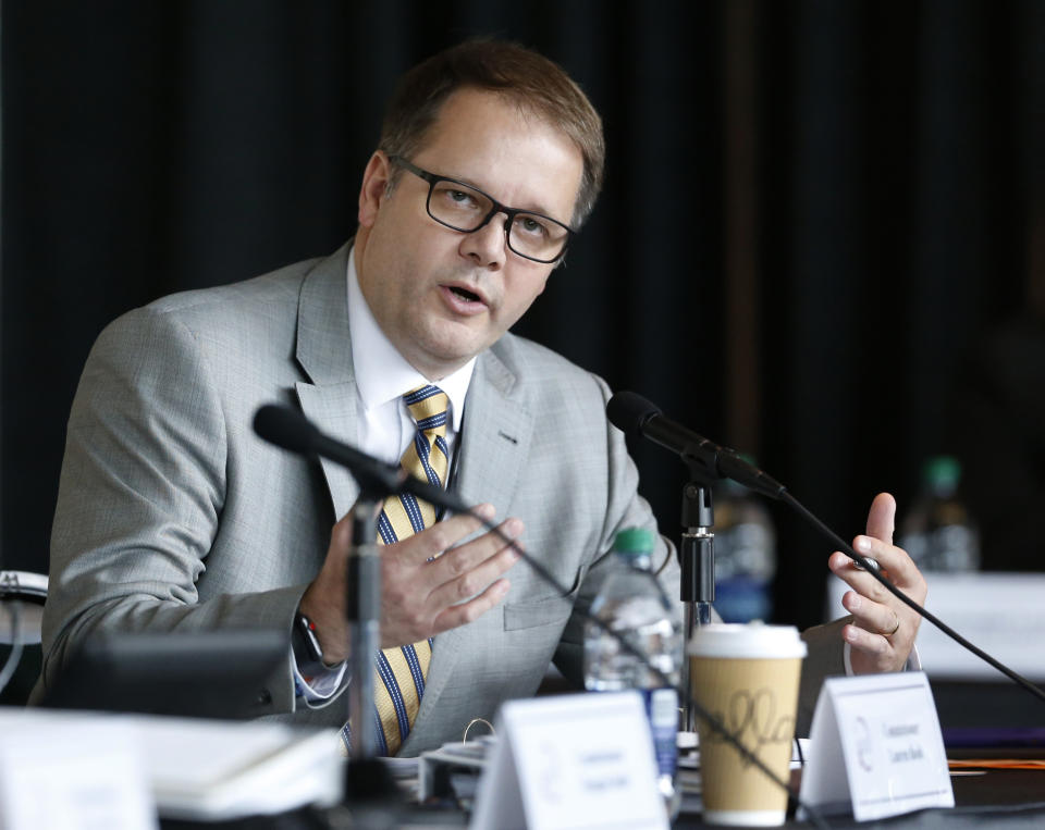 FILE - In this June 7, 2018, file photo, Ryan Petty asks a question during the Marjory Stoneman Douglas High School Public Safety Commission Meeting in Sunrise, Fla. Petty, whose 14-year-old daughter Alaina died, was appointed to the state commission investigating its causes. His comments, usually delivered coolly and to the point, tended to hit at police and school system failures he perceived. He lost a bid for the Broward County school board, but was also part of Gov. Ron DeSantis' transition team. (AP Photo/Wilfredo Lee, File)