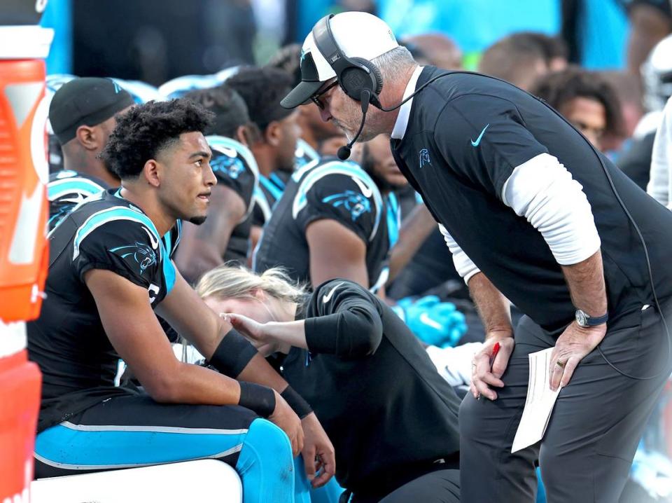 Carolina Panthers quarterback Bryce Young, left, listens to head coach Frank Reich, right, during second half action against the Dallas Cowboys at Bank of America Stadium in Charlotte, NC on Sunday, November 19, 2023. The Cowboys defeated the Panthers 33-10.