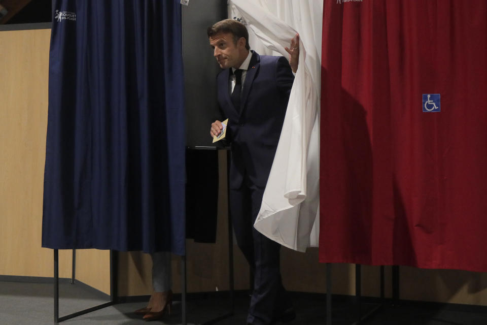French President Emmanuel Macron leaves the voting booth Sunday, June 19, 2022 in Le Touquet, northern France. French voters are going to the polls in the final round of key parliamentary elections that will demonstrate how much legroom President Emmanuel Macron's party will be given to implement his ambitious domestic agenda. (AP Photo/Michel Spingler, Pool)