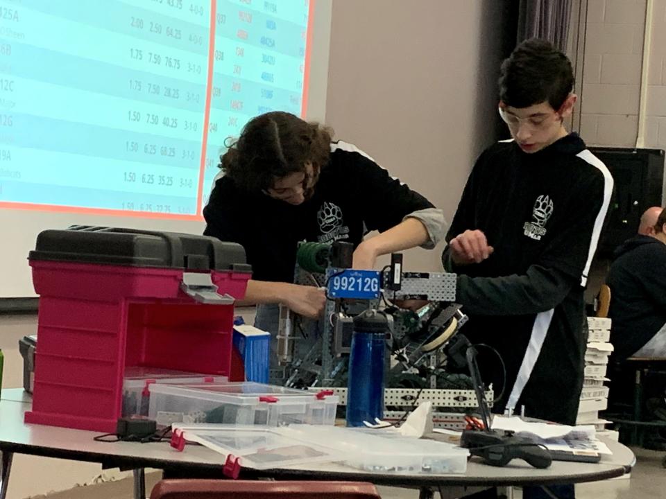 Coe-Brown Northwood Academy students Eve Dearborn ‘24 and Eli Dearborn ‘26 work on their robot at the Belmont High School meet on Jan. 14, 2023.