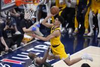 Indiana Pacers' Ben Sheppard, right, is called for an offensive foul against Milwaukee Bucks' Khris Middleton during the first half of Game 4 of the first round NBA playoff basketball series, Sunday, April 28, 2024, in Indianapolis. (AP Photo/Michael Conroy)