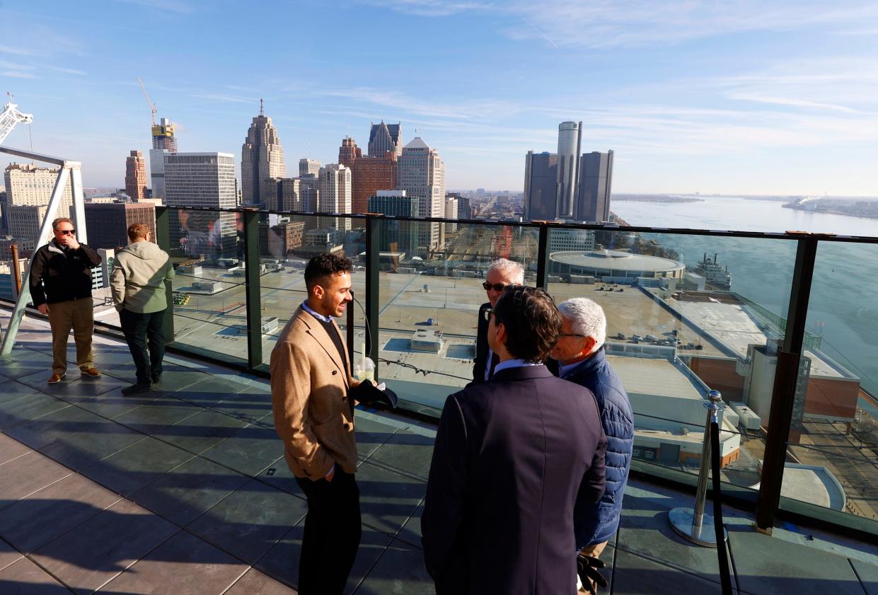 People talk on the 25th floor observation area with the Detroit skyline in the background at the Residences at Water Square, a new luxury apartment tower at the site of the former Joe Louis Arena in Detroit on Tuesday, Feb. 6, 2024.