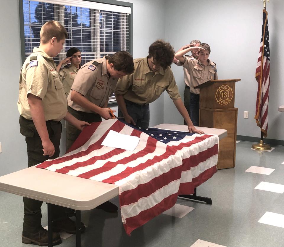 Before an American flag is disposed of properly, its stars and stripes are separated.