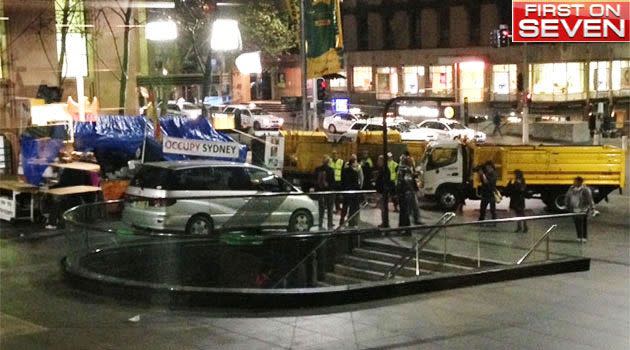 Police and city council workers move in to dismantle the Occupy Sydney camp. Photo: 7News