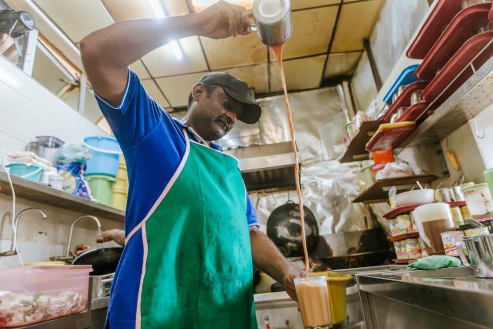 Drinks stall vendor Gopinand prepares drinks at his stall in Putrajaya March 7, 2024.  — Picture by Raymond Manuel