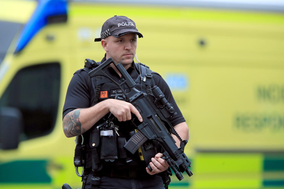 An armed police officer outside the Arndale Centre in Manchester where at least five people have been treated after a stabbing incident.