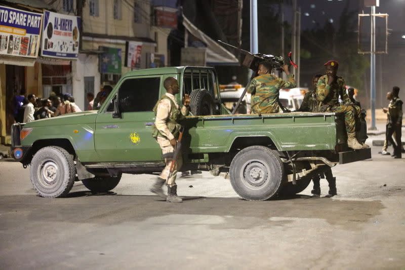 Somali security officers secure the scene of a car bomb explosion in the Kilometre 4 area of Mogadishu