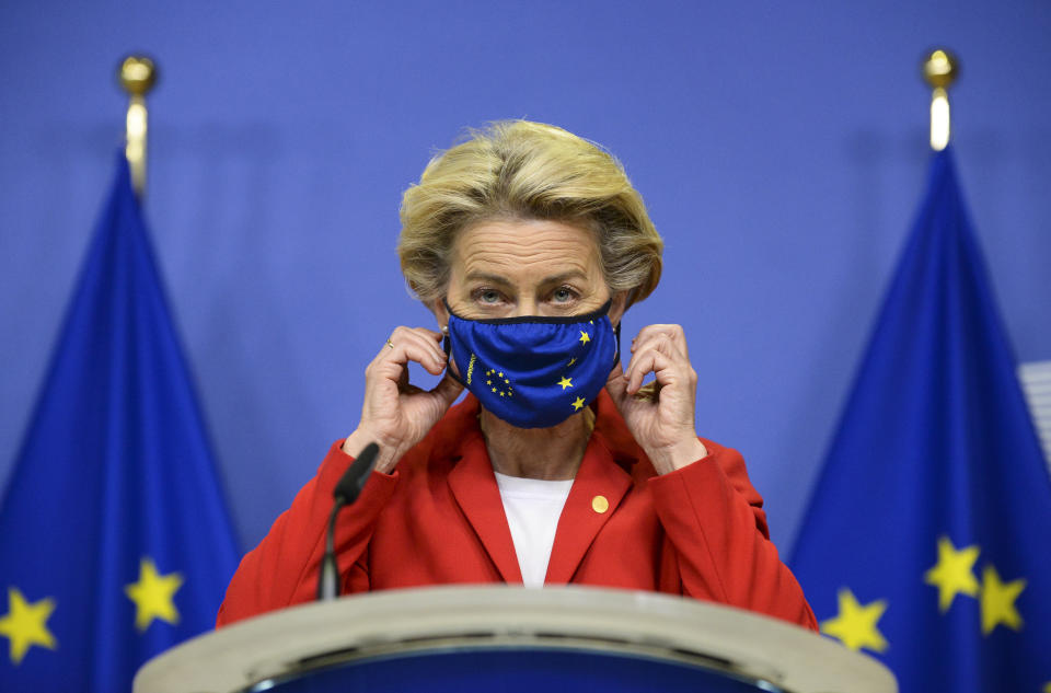 European Commission President Ursula von der Leyen, takes off her protective mask prior to making a statement regarding the Withdrawal Agreement at EU headquarters in Brussels, Thursday, Oct. 1, 2020. The European Union took legal action against Britain on Thursday over its plans to pass legislation that would breach parts of the legally binding divorce agreement the two sides reached late last year. (Johanna Geron, Pool via AP)