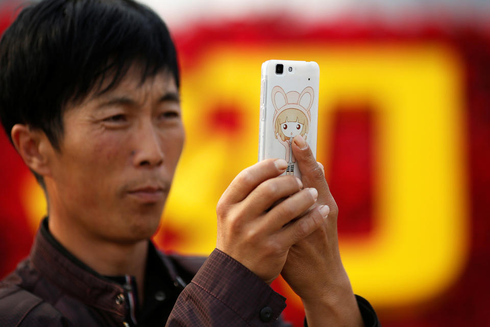 <p>A man takes pictures of himself as people gather in Tiananmen Square to celebrate National Day marking the 67th anniversary of the founding of the People’s Republic of China, in Beijing October 1, 2016. (REUTERS/Damir Sagolj) </p>